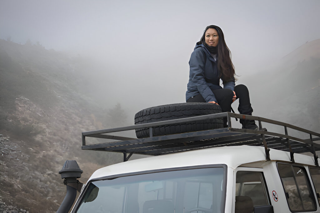 Adventure Seekers Guide: Off-Road Car Rentals for Albania's Wild North 4 Off-road car rentals in Albania navigating a rocky riverbed in the wild north, with snow-capped mountains in the background, perfect for adventure seekers.